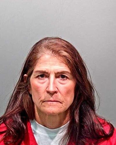 Missy Woods, former CBI forensic scientist, booked into jail Wednesday on 102 felony charges