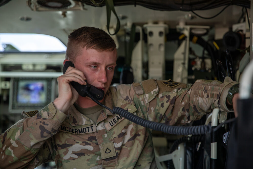 A Fort Carson speaks on a phone receiver to send a situation report in a Stryker, at Fort Carson, Colorado. 